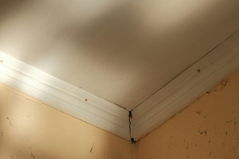 Daylight through a damaged ceiling corner after a leak